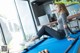 A woman sitting on top of a pool table.