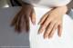 A woman's hands on a white table.