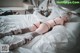 A woman laying on top of a bed in lingerie.