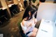 A woman sitting at a desk in front of a computer.